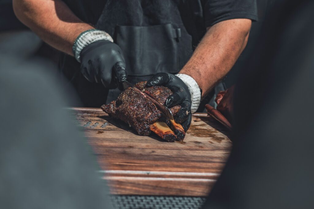 BBQ pitmaster cutting meat