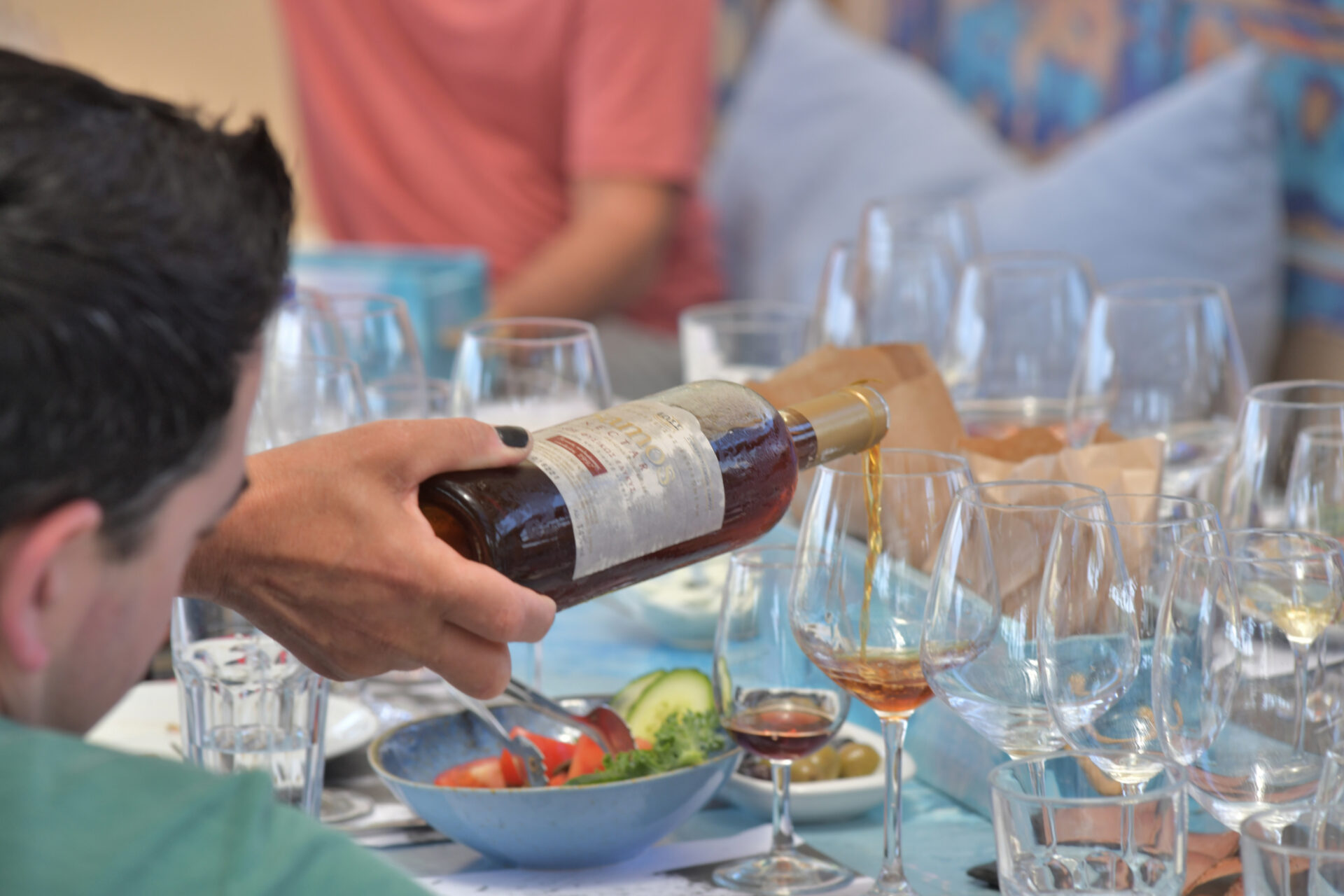 Man pouring wine at a dinner.