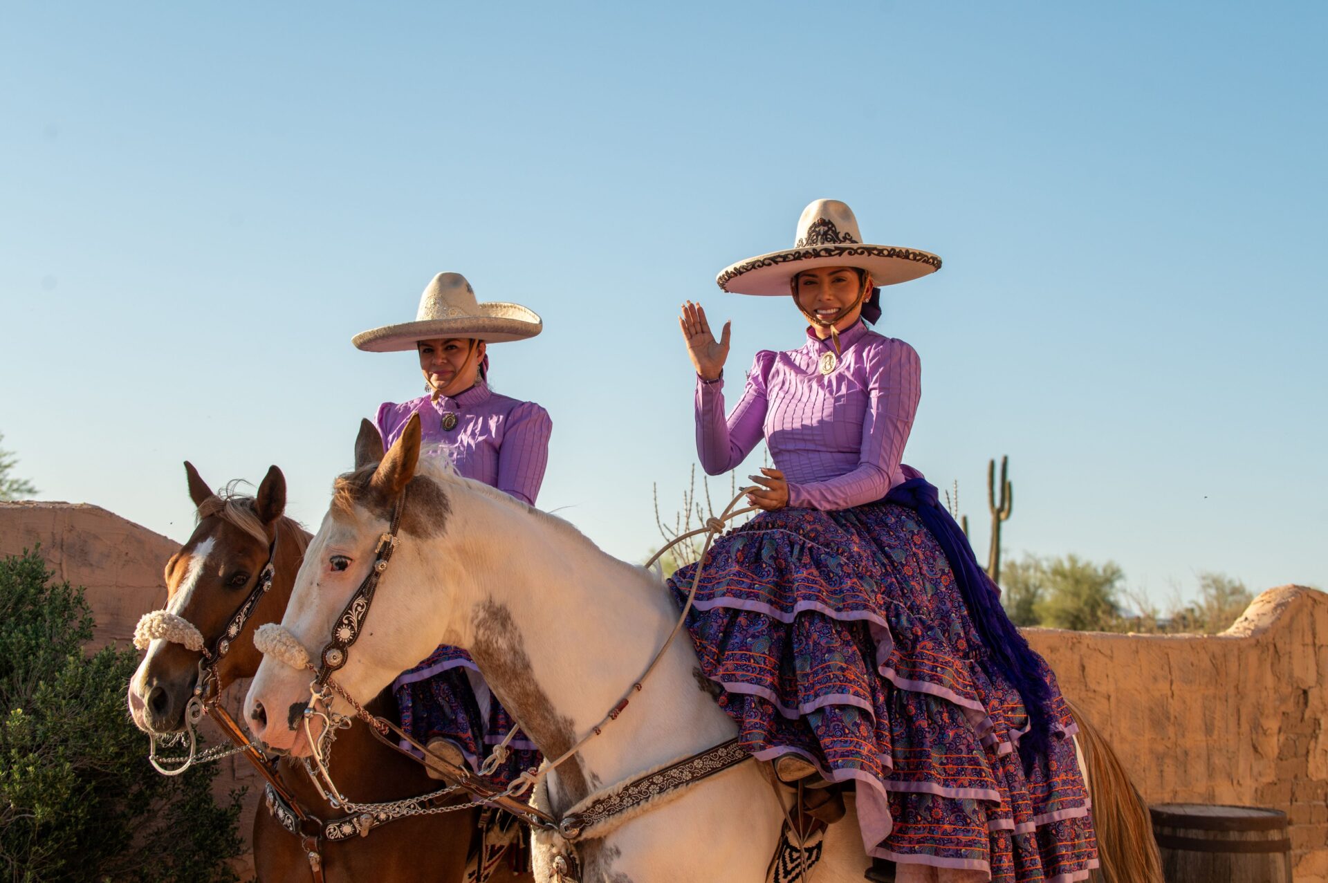 Two locals welcome guests to Arizona event on horseback