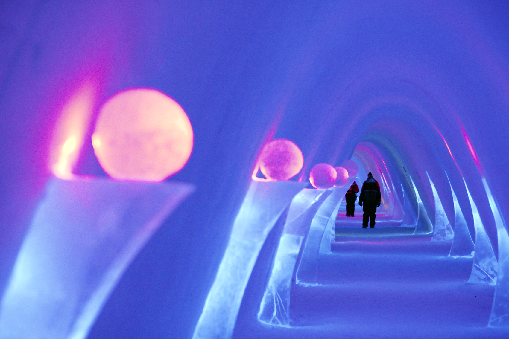 People standing in an ice cave
