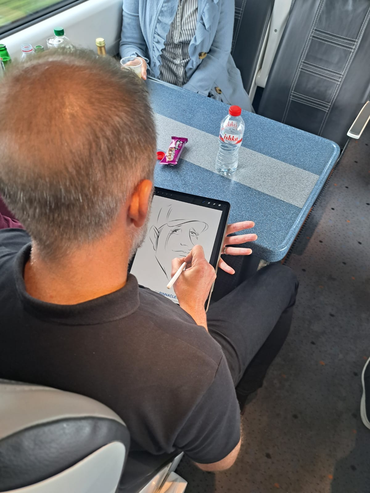 Caricaturist on the train to/from Dublin