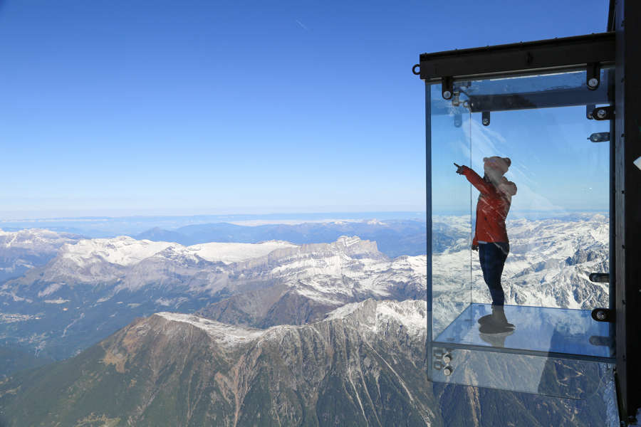 Aerial of glass enclosure with view of the Alps