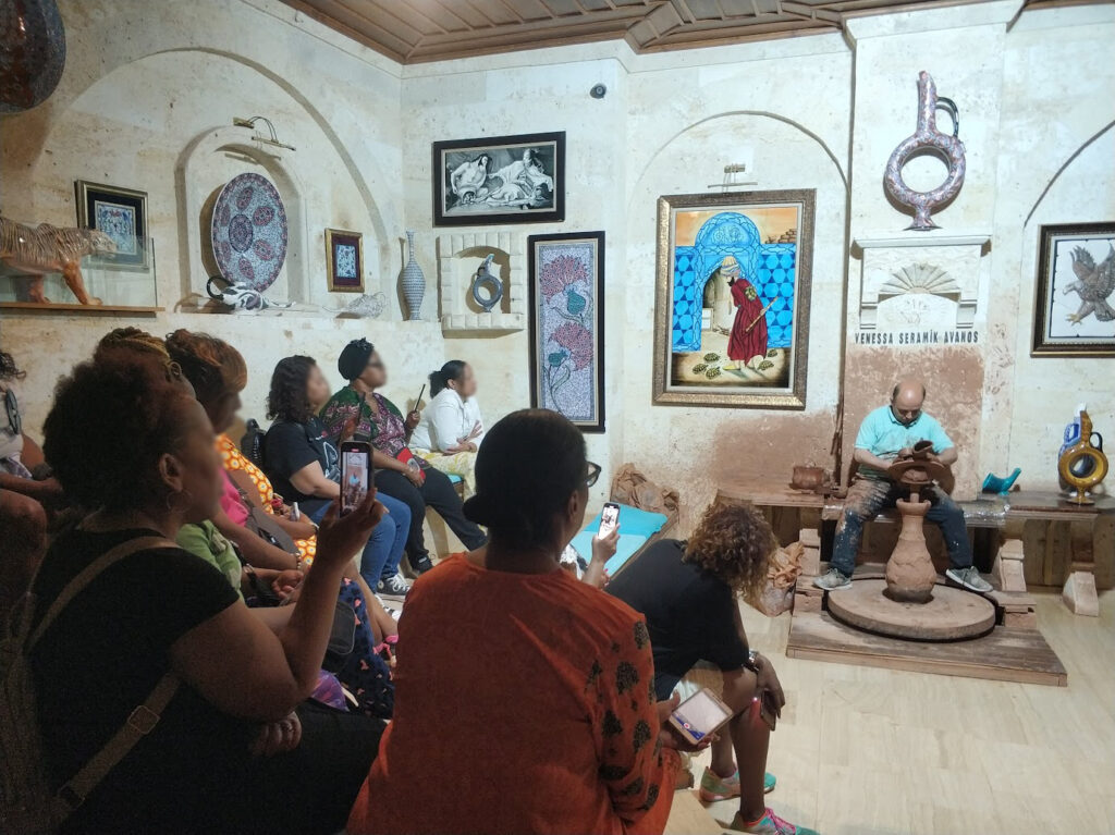 Students listening in a Pottery Making Class