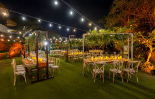Chairs on a lawn with string lights